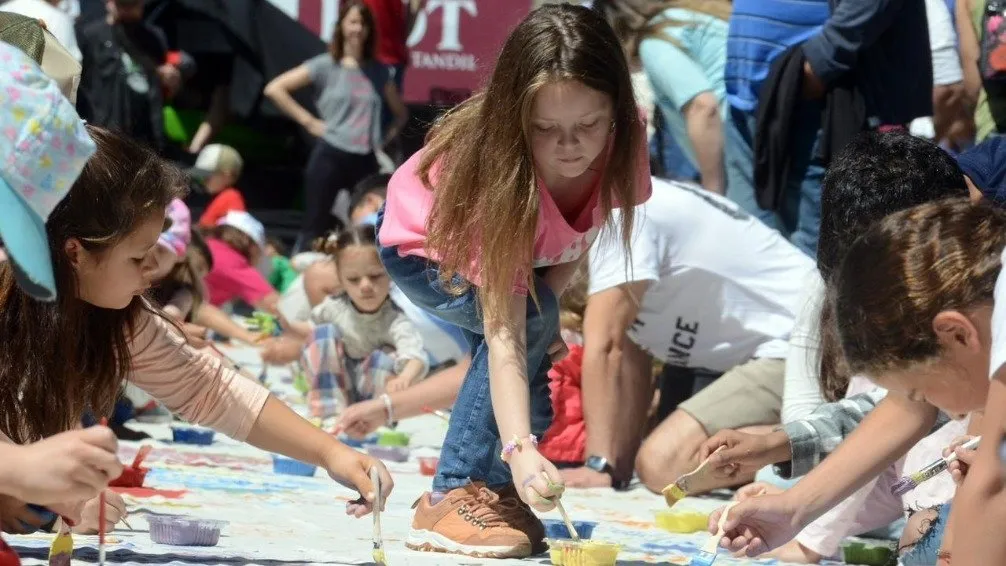 Cientos de niños y niñas de Tandil pintaron la bandera de Chacinar junto a Milo Lockett y Manuel Paz